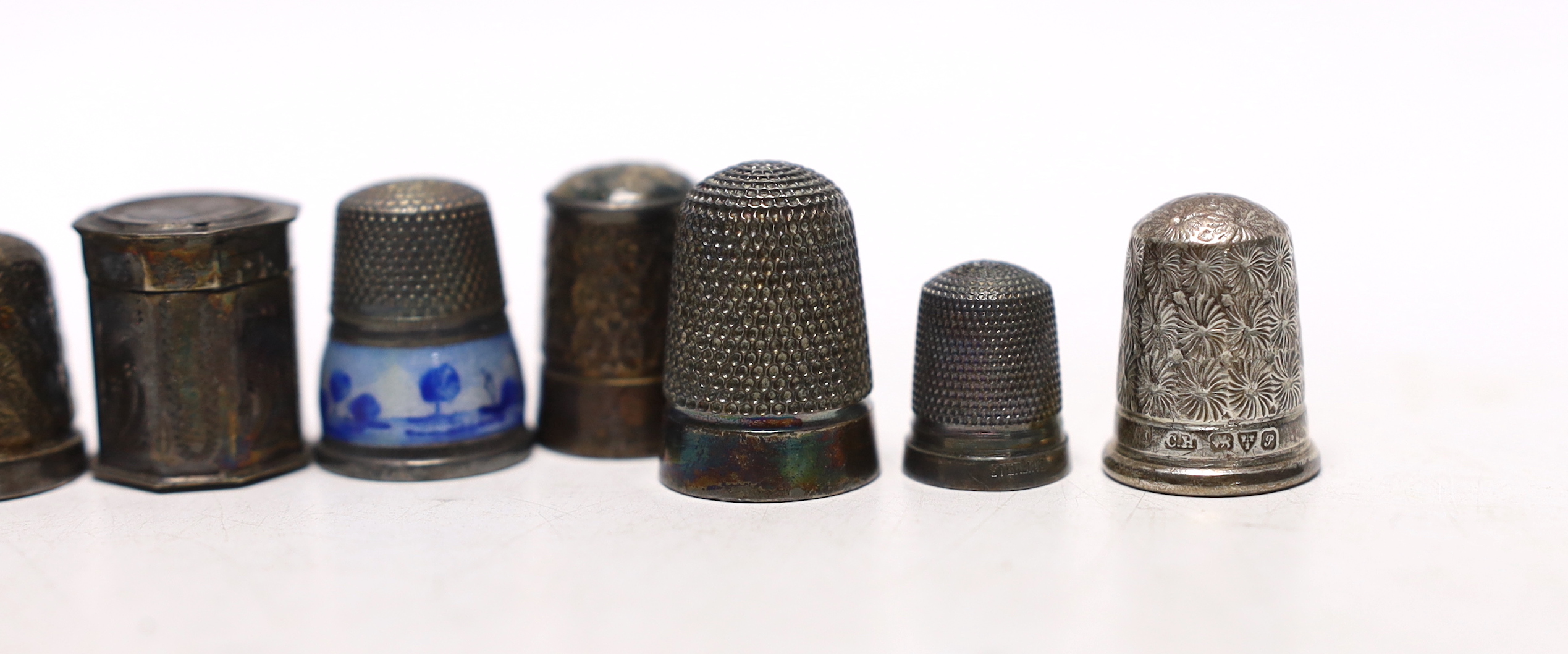 Seven assorted early 20th century and later silver thimbles, including two enamelled and a Dutch? white metal octagonal thimble case.
